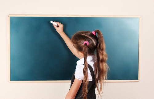 girl writing on board